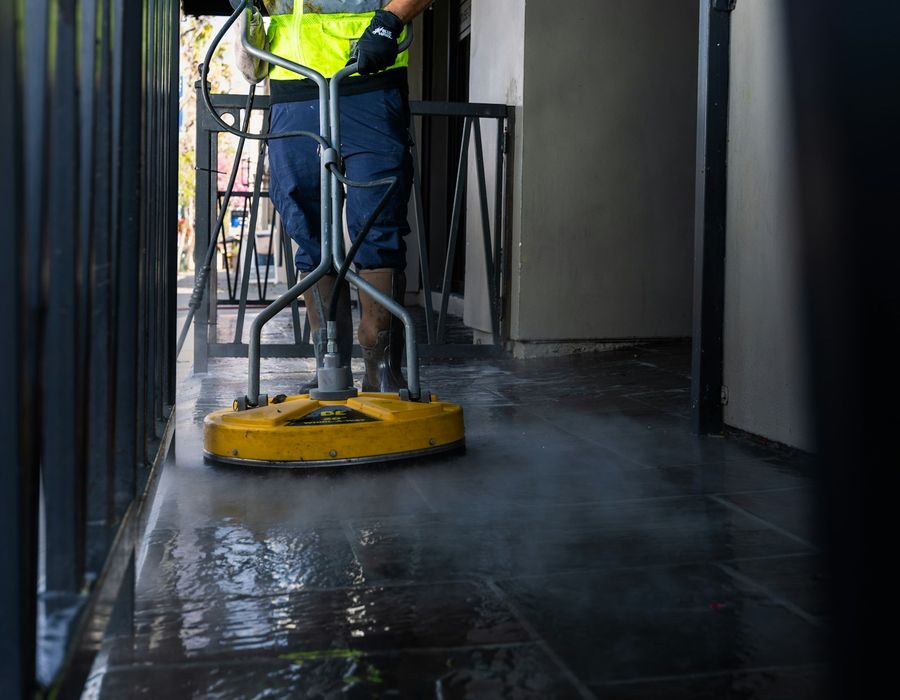 Cleaner mopping an office corridor after hours