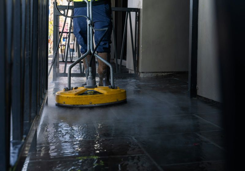 Cleaner mopping a commercial corridor after hours